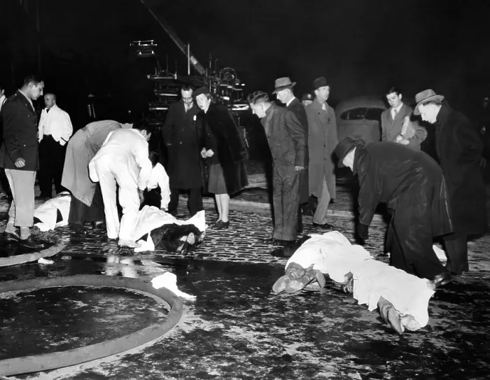 Framed Print : Coconut Grove Nightclub Fire. Four bodies covered with sheets in the street waiting transport to Boston's overwhelmed morgues. Nov. 29, 1942