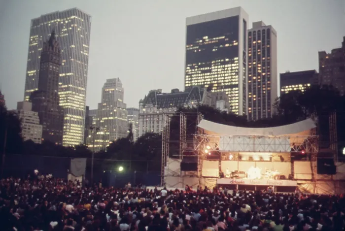 Framed Print : Concert in Central Park. The joys of urban live include events like the Judy Collins concert at the Schaefer Bandstand in Central Parks with its backdrop of midtown skyscrapers Framed Print : Concert in Central Park. The joys of urban live include events like the Judy Collins concert at the Schaefer Bandstand in Central Parks with its backdrop of midtown skyscrapers