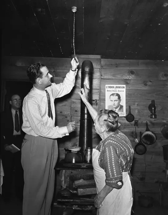Framed Print : Congressman Lyndon Johnson examines Mrs. Mattie Malone's new electric light fixture in Carthage, Texas Framed Print : Congressman Lyndon Johnson examines Mrs. Mattie Malone's new electric light fixture in Carthage, Texas