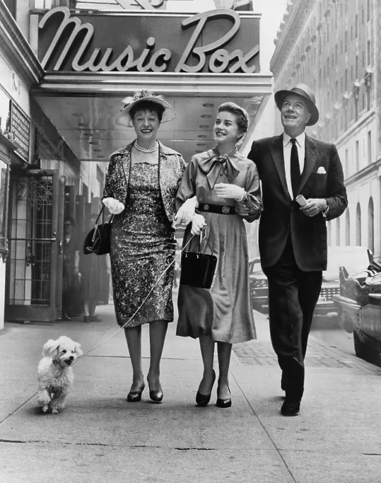 Framed Print : Cornelia Otis Skinner, Dolores Hart with dog on leash, and Cyril Ritchard, walking outside the Music Box theatre where they are starring in THE PLEASURE OF HIS COMPANY in 1959