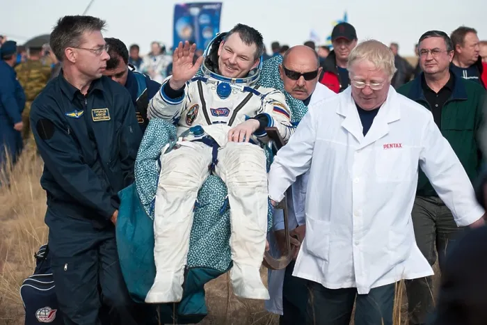 Framed Print : Cosmonaut Alexander Samokutyaev carried after returning from over five months aboard the International Space Station