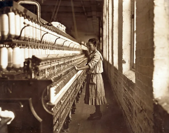 Framed Print : Cotton Mill. An underage girl tends a cotton spinner for 48 cents a day. Whitnel, North Carolina. Photo by Lewis Hine Wickes, Dec 1908