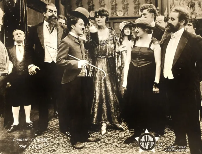 Framed Print : THE COUNT, foreground left: Charlie Chaplin, foreground second from right: Edna Purviance, 1916