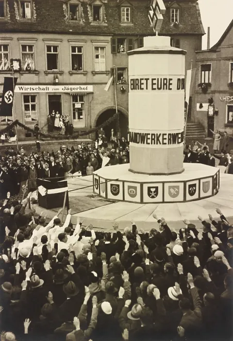 Framed Print : Crowd in Ottweiler, Germany, saluting an unidentified Nazi monument in 1933. Hanging garlands and a swasticka banner decorate the area Framed Print : Crowd in Ottweiler, Germany, saluting an unidentified Nazi monument in 1933. Hanging garlands and a swasticka banner decorate the area