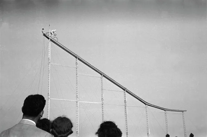 Framed Print : Daredevil preparing to dive into water from cycle down an elevated incline, by Lee Russell, state fair, Donaldsonville, Louisiana, November, 1938 Framed Print : Daredevil preparing to dive into water from cycle down an elevated incline, by Lee Russell, state fair, Donaldsonville, Louisiana, November, 1938