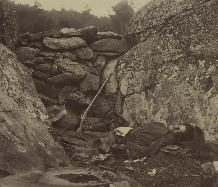 Framed Print : Dead Confederate soldier lies in the Devil's Den, against the wall of stones, with his rifle, on the Gettysburg battlefield, c. July 4-6, 1863