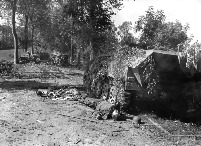 Framed Print : Dead German soldier lies beside a wrecked half-track near Mortain Framed Print : Dead German soldier lies beside a wrecked half-track near Mortain