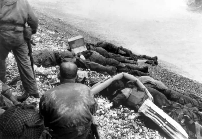Framed Print : Dead U.S. soldiers Omaha beach on D-Day, June 6, 1944. Some bodies are covered with lifebuoys, and one of them has the face covered by a cardboard box Framed Print : Dead U.S. soldiers Omaha beach on D-Day, June 6, 1944. Some bodies are covered with lifebuoys, and one of them has the face covered by a cardboard box