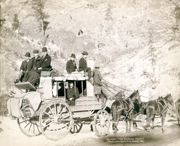 Framed Print : The Deadwood Coach. Side view of a stagecoach; formally dressed men sitting in and on top of coach. Deadwood, SD. John C. Grabill, 1889 Framed Print : The Deadwood Coach. Side view of a stagecoach; formally dressed men sitting in and on top of coach. Deadwood, SD. John C. Grabill, 1889