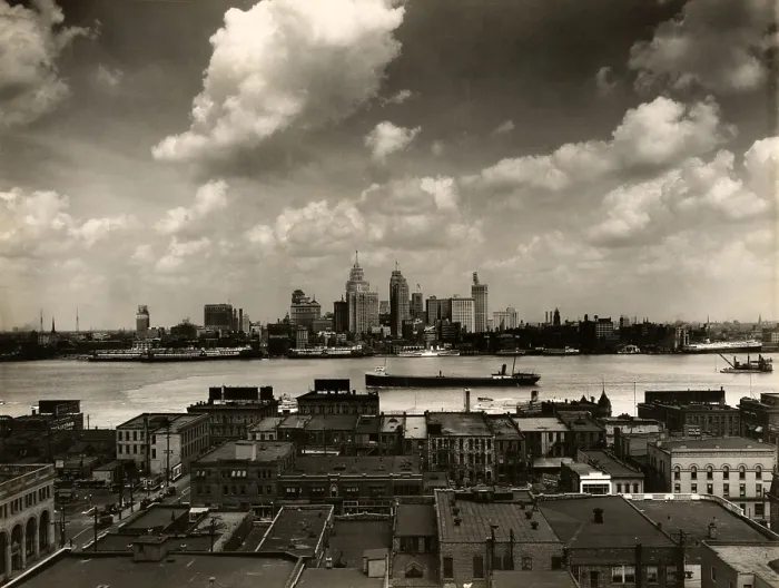 Framed Print : Detroit. The Detroit skyline and boats on the Detroit River as seen from Windsor, Ontario. In foreground, rooftops of buildings in Windsor. 1929
