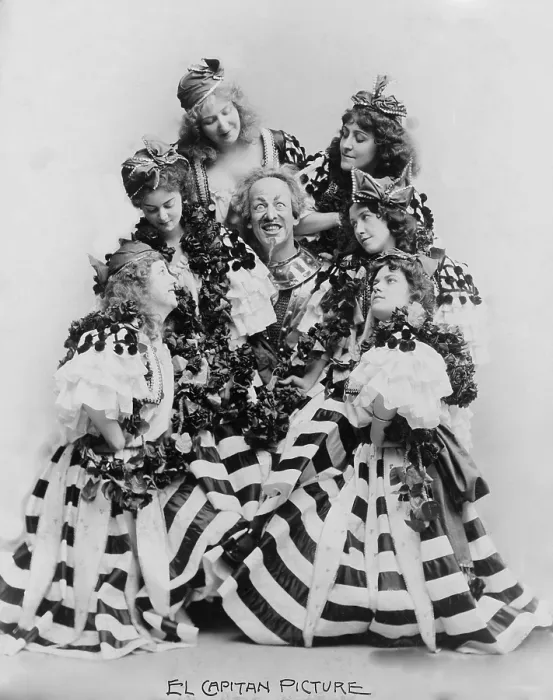 Framed Print : DeWolf Hopper, (1858-1935) surrounded by six women, all in costume, starring in Sousa's El Capitan