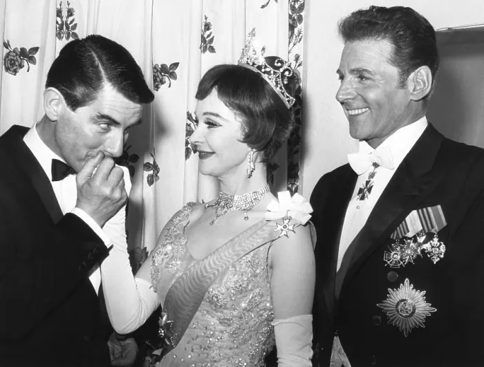 Framed Print : Director Peter Glenville kisses hand of Vivien Leigh's hand with actor Jean Pierre Aumont at right. March 18, 1963