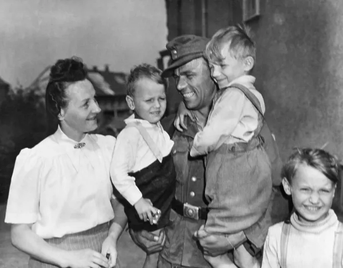 Framed Print : Discharged German soldier Fritz Reidel returned to his wife and children, May 21, 1945. U.S. military began discharging German soldiers after medical exams and fingerprinting Framed Print : Discharged German soldier Fritz Reidel returned to his wife and children, May 21, 1945. U.S. military began discharging German soldiers after medical exams and fingerprinting