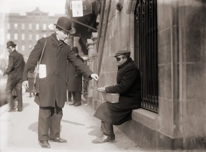 Framed Print : Disfigured beggar receiving change on a street in New York City, 1910 Framed Print : Disfigured beggar receiving change on a street in New York City, 1910