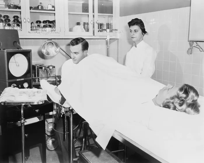 Framed Print : Doctor performs a Rubin test, at the infertility clinic at Long Island Jewish Hospital. The test detected fallopian tube blockages and is now replaced by laparoscopy. 1956