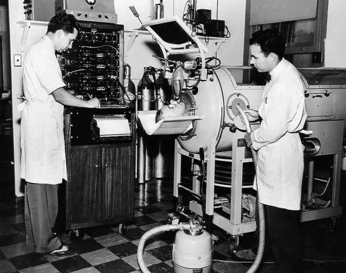 Framed Print : Doctors are studying the mechanism of cough in a polio patient in an Iron Lung respirator. Rancho Los Amigos Respirator Center, Hondo, California. 1953 Framed Print : Doctors are studying the mechanism of cough in a polio patient in an Iron Lung respirator. Rancho Los Amigos Respirator Center, Hondo, California. 1953
