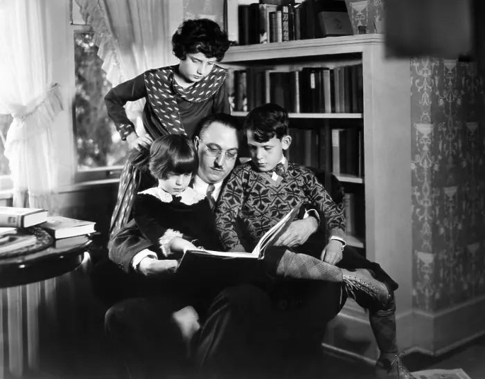 Framed Print : Dr. Karl A. Menninger, psychiatrist, with his children. Ca. 1930. They are playing anagrams. Julia is standing, while Martha and Robert sit with their father. (CSU_2015_11_1627)