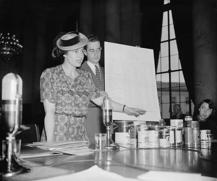 Framed Print : Dr. Ruth W. Ayers an economist testifying before the Congressional Monopoly Committee shows investigators examples of confusing