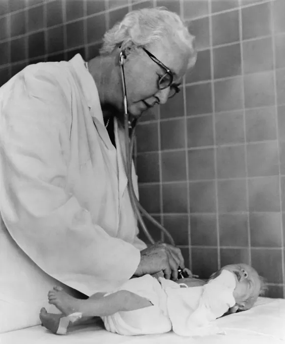 Framed Print : Dr. Virginia Apgar examining a newborn baby with stethoscope, Oct. 2, 1966. She introduced the Apgar Score, a way to quickly assess the health of newborns