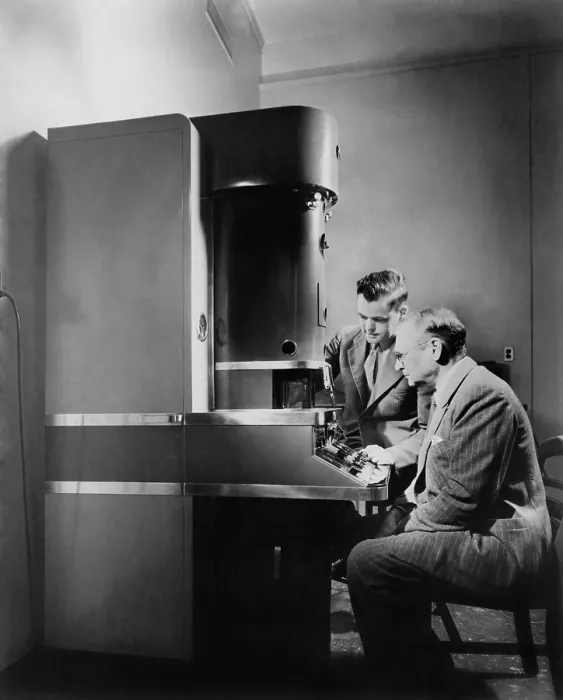 Framed Print : Dr. V.K. Zworykin and Dr. James Hillier of RCA Laboratories at the electron microscope. Invented in the 1930, it exceeded magnification of optical microscopes. Ca. 1945