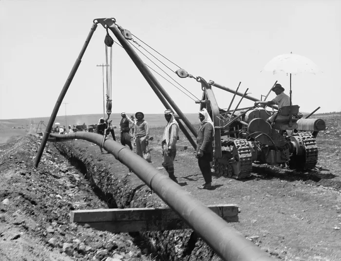 Framed Print : Dropping a welded pipe into a trench with a crane while laying the Iraq Petroleum Company's pipe line across Palestine's Plain of Esdraelon, July 1933
