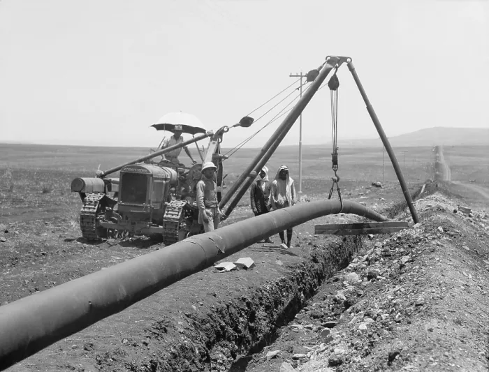Framed Print : Dropping a welded pipe into a trench with a crane while laying the Iraq Petroleum Company's pipe line across Palestine's Plain of Esdraelon, July 1933 Framed Print : Dropping a welded pipe into a trench with a crane while laying the Iraq Petroleum Company's pipe line across Palestine's Plain of Esdraelon, July 1933