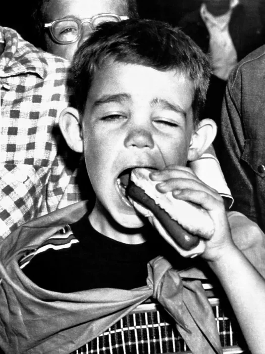 Framed Print : Dwight David Eisenhower II. He eats a hot-dog at a picnic given for him by his grandfather, President Eisenhower at Aksel Eielsen's Byers Peak ranch near Fraser, Colo