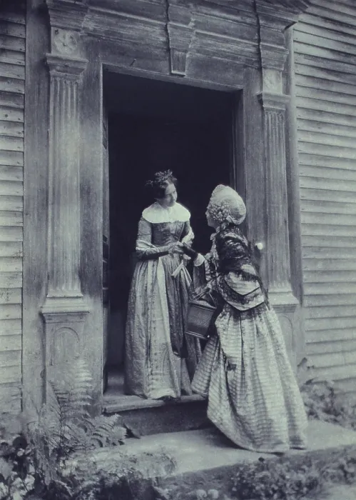 Framed Print : HOW DY DO? Staged photograph of two women, in mid-19th century period costumes, standing in a doorway conversing