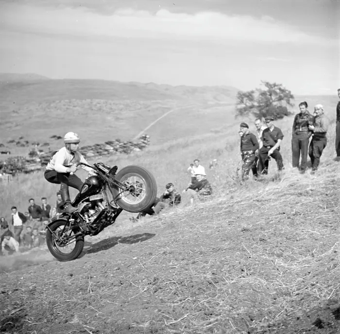 Framed Print : An early motorcycle club watches as a member pops a wheelie on an uphill climb. Santa Clara County, California ca. 1940 Framed Print : An early motorcycle club watches as a member pops a wheelie on an uphill climb. Santa Clara County, California ca. 1940