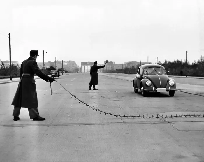 Framed Print : East Berlin customs police stopping a Volkswagen on the Charlettenburger Chaussee with a tire puncturing heavy barbed chain. Oct. 26, 1952 Framed Print : East Berlin customs police stopping a Volkswagen on the Charlettenburger Chaussee with a tire puncturing heavy barbed chain. Oct. 26, 1952