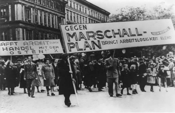 Framed Print : East Germans demonstrate against Marshall Plan. The sign translates to Against Marshall Plan Brings Unemployment Misery'. Ca. 1952. (BSLOC_2014_13_30)