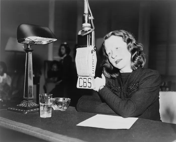 Framed Print : Edna St. Vincent Millay (1892-1950) American poet seated behind CBS microphone speaking on the CHILDREN ARE ALSO PEOPLE program. 1945