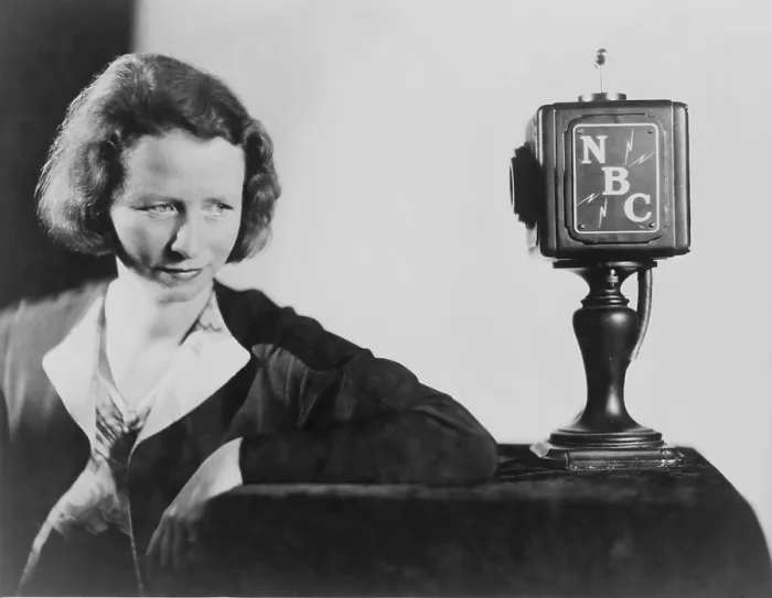 Framed Print : Edna St. Vincent Millay (1892-1950) American poet, seated behind NBC microphone reciting her poetry. 1945