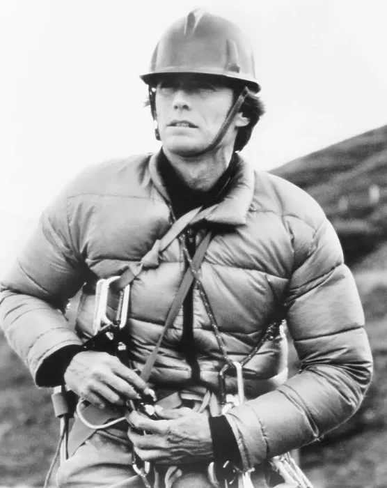Framed Print : THE EIGER SANCTION, Clint Eastwood straps on equipment for a day's filming on the north face of Switzerland's Eiger Mountain, 1975