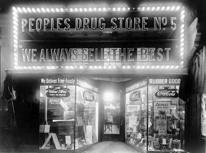 Framed Print : Electric lights and brand names advertise the People's Drug Store at 8th & H Streets, N.E. Washington, D.C. in 1920