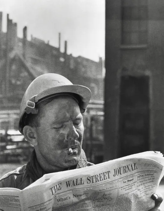 Framed Print : An electrician reads The Wall Street Journal to check his stock market investments Framed Print : An electrician reads The Wall Street Journal to check his stock market investments