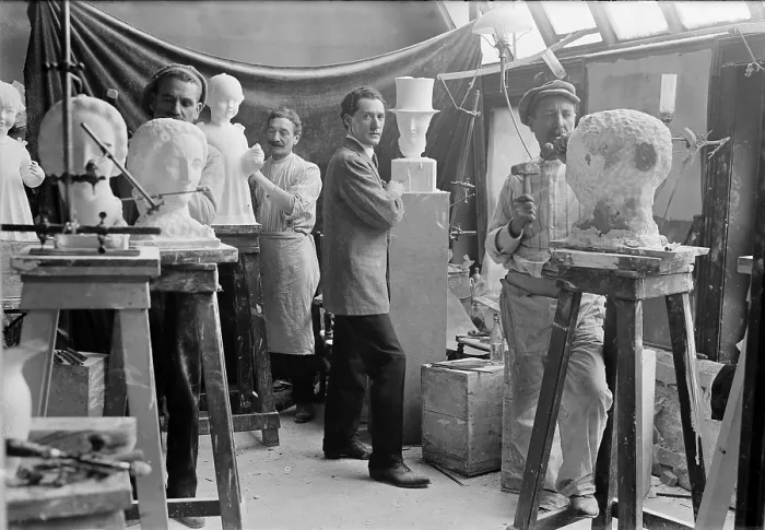 Framed Print : Elie Nadelman (1882-1946), Polish-born American sculptor standing beside his sculpture in an artists studio class. Ca. 1915