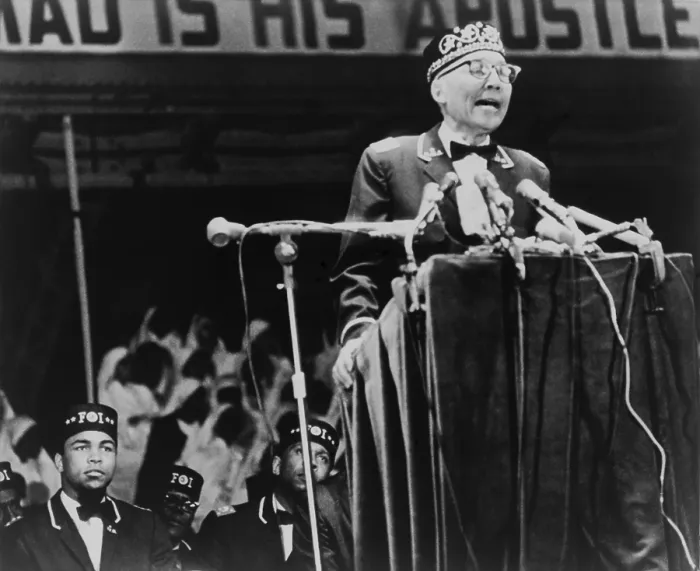 Framed Print : Elijah Muhammad, leader of the Black Muslims, addressing a convention in Chicago. World champion boxer, Muhammad Ali, sits on the left. 1967