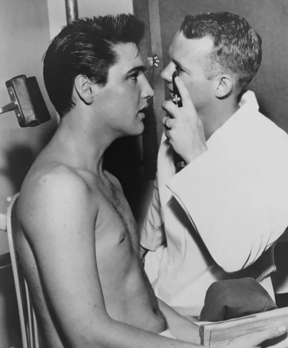 Framed Print : Elvis Presley, while being examined by Dr. Fred Jeff Burford, as part of induction into the army. 1958