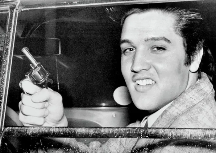 Framed Print : Elvis Presley holding the toy pistol he claimed he used in settling dispute with Marine Private Hershel Nixon, who claims Presley pulled a real gun, 1957 Framed Print : Elvis Presley holding the toy pistol he claimed he used in settling dispute with Marine Private Hershel Nixon, who claims Presley pulled a real gun, 1957