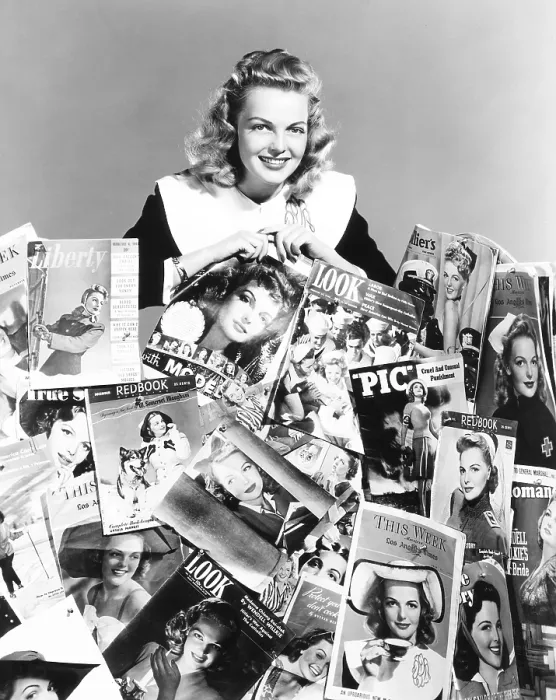 Framed Print : Elyse Knox posing amid all of the magazines which feature her picture on the cover, 1943