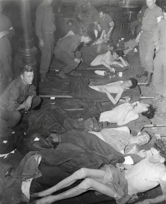 Framed Print : Emaciated American POWs taken prisoner Battle of the Bulge receive medical care. Only 63 men survived of 350 prisoners taken five months earlier