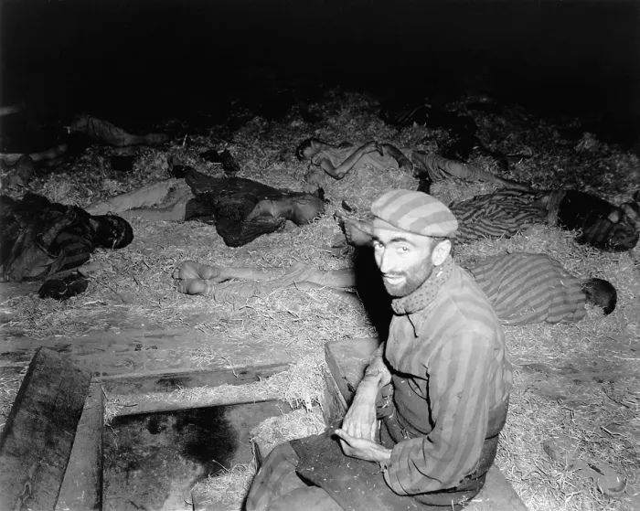 Framed Print : Emaciated Frenchman sitting among the dead in prison camp, Nordhausen, Germany after liberation by First U.S. Army on April 11, 1945