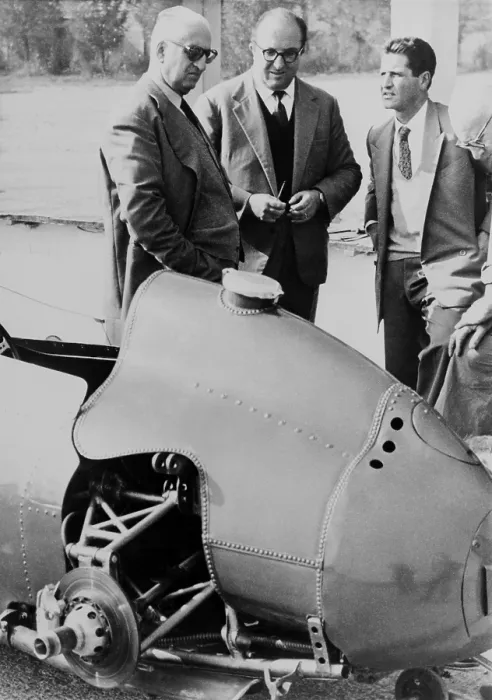 Framed Print : Enzo Ferrari (left), founder and owner of the Ferrari Auto factories Modena, Italy, looks over a 1959 racing car with technicians