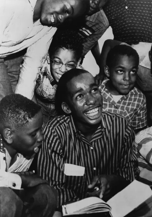 Framed Print : Ernest Green, one of the Little Rock Nine, shows his new textbook to his friends, after his first full day at Little Rock Central High School