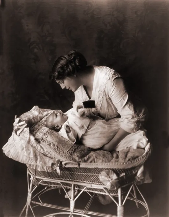 Framed Print : Ethel Barrymore (1879-1959), leaning over the crib of her third child, John Drew Colt (1913-1975) in 1913