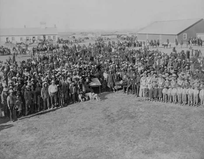 Framed Print : Euro-American census takers sit at two tables in front of a large crowd of Native Americans at Standing Rock Agency, South Dakota, ca. 1880-1900