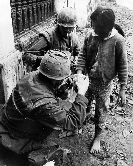Framed Print : EV1949 - Two U.S. Marines apply bandages to the hand of a Vietnamese girl who was wounded during street fighting in Hue, South Vietnam, February 11, 1968