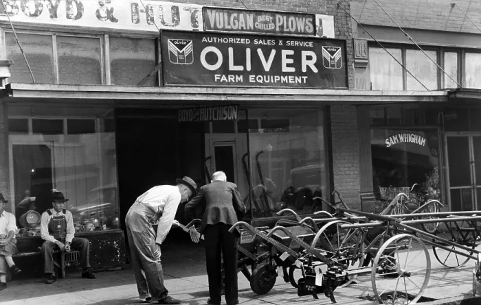 Framed Print : Farmer looking at new equipment, Saturday afternoon, Enterprise, Alabama, photograph by Marion Post Wolcott, circa 1939