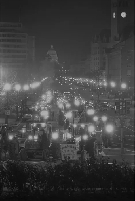 Framed Print : Farmers driving tractors down Pennsylvania Avenue as part of a night time American Agriculture Movement protest for higher government farms subsidies